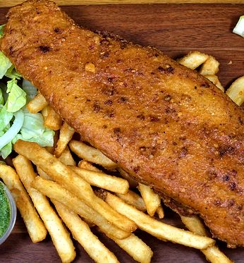 Spicy battered fish with fries, lettuce and tomato salad, green chutney and lemon