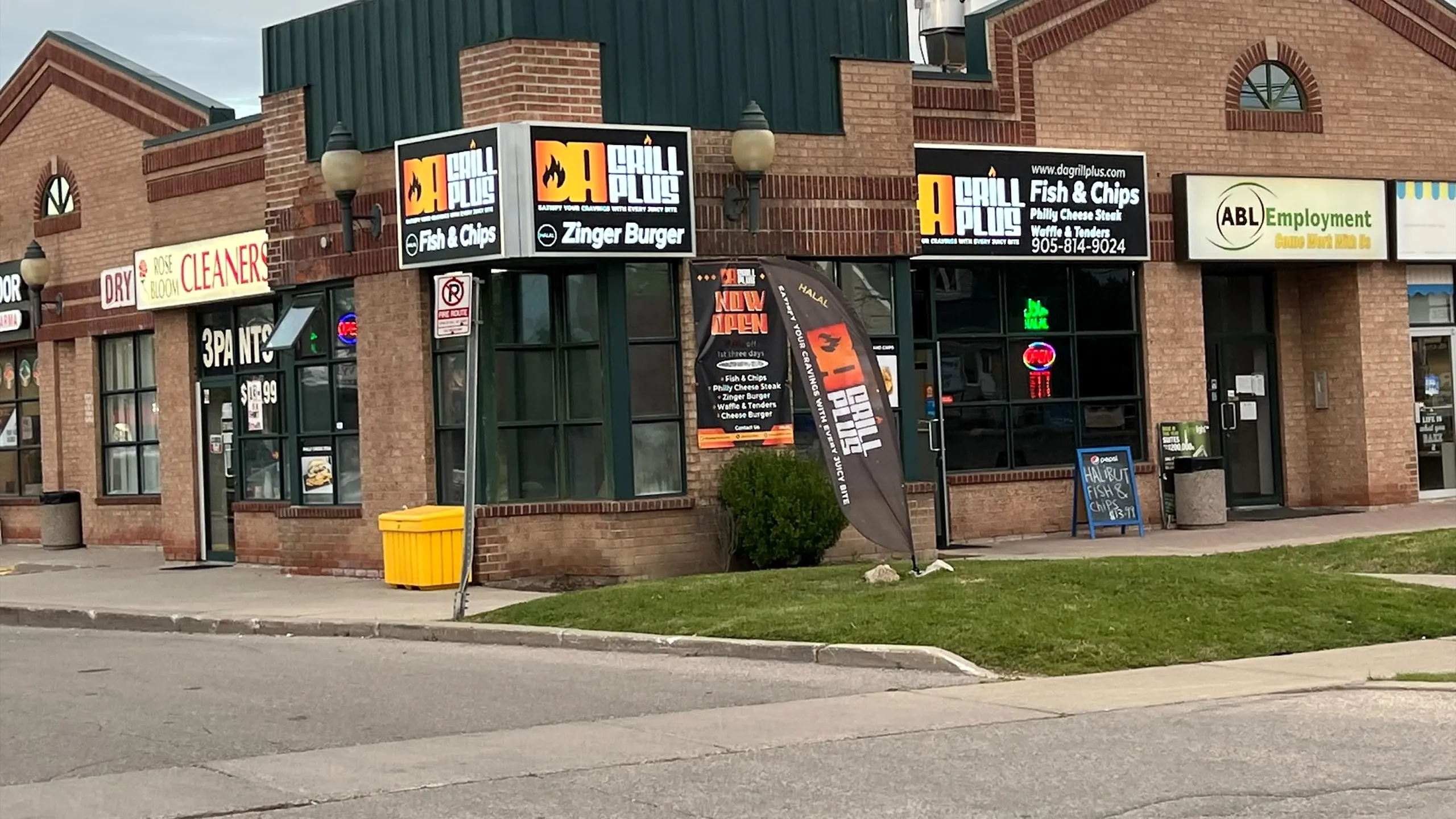 Da Grill Plus storefront on Queen Street North with its Fish & Chips and Zinger Burger signs
